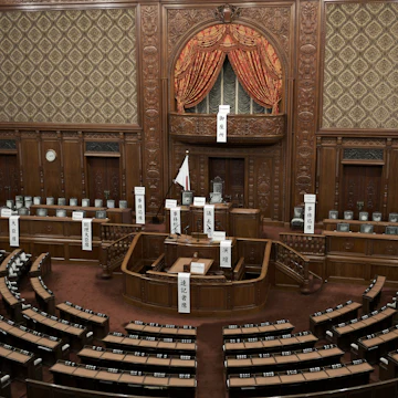 The Chamber of the House of Representatives in the National Diet Building, located in Tokyo, Japan, is a significant and impressive space where legislative activities take place. This chamber is characterized by its large, semicircular arrangement of seats, designed to facilitate debate and discussion among the representatives. The interior features a blend of traditional Japanese and Western architectural elements, with a prominent central podium and a gallery for public viewing. The chamber's design emphasizes transparency and democracy, highlighted by the use of natural light and symbolic decorative elements. As the primary venue for Japan's legislative process, it holds a pivotal role in the country's political landscape.
1939346721
