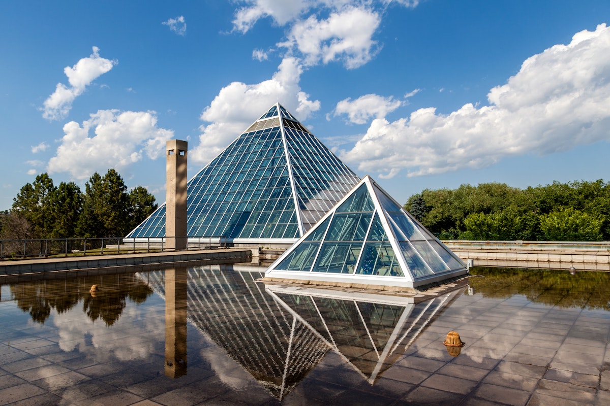 Edmonton, Canada - July 8, 2014: A Summer view of the Muttart Conservatory, one of Edmonton's most famous icons built in 1976 by architect Peter Hemingway. The conservatory features unique greenhouses and gardens that display plant species found across three biomes,
506715369
Alberta, Architecture, Beauty, Botany, Building Exterior, Built Structure, Canada, City Life, Contemporary, Creativity, Ecosystem, Edmonton, Fame, Famous Place, Formal Garden, Glass, Greenhouse, Inspiration, International Landmark, Multi Colored, Muttart, Muttart Conservatory, Nature, Ornamental Garden, Outdoors, Plant, Pyramid, Pyramid Shape, Scenics, Sky, Tranquil Scene, Urban Scene, Vitality, Window, botanic, glass building