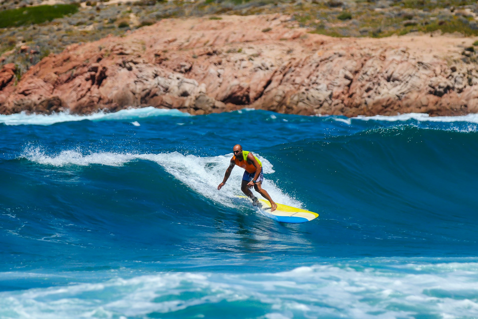 A surfer catches a wave during the Mistral, Isola Rossa, Sardinia, Italy
