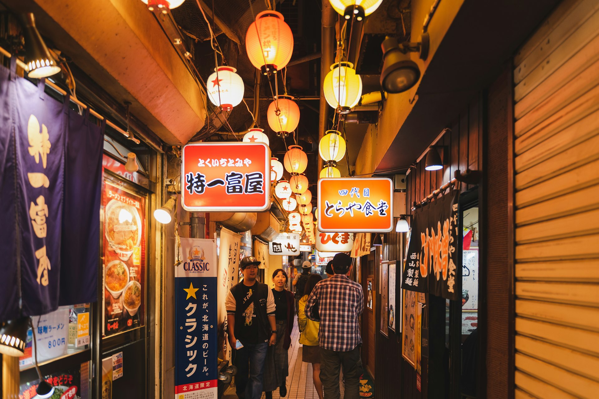 People in an alley packed with ramen restaurants, Ganso Sapporo Ramen Yokocho, Sapporo, Hokkaidō, Japan