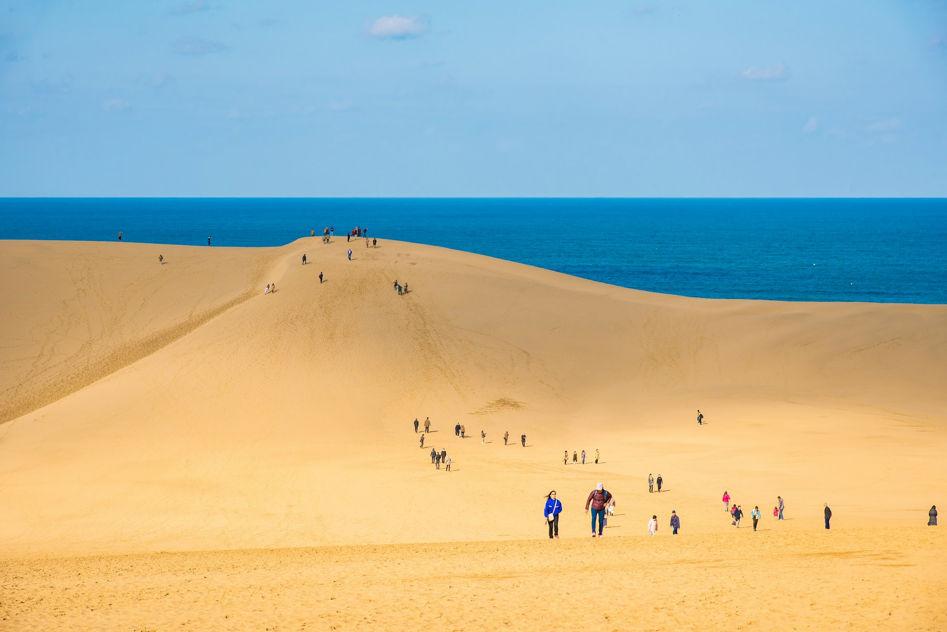 People on the sand dunes of Tottori, western Japan