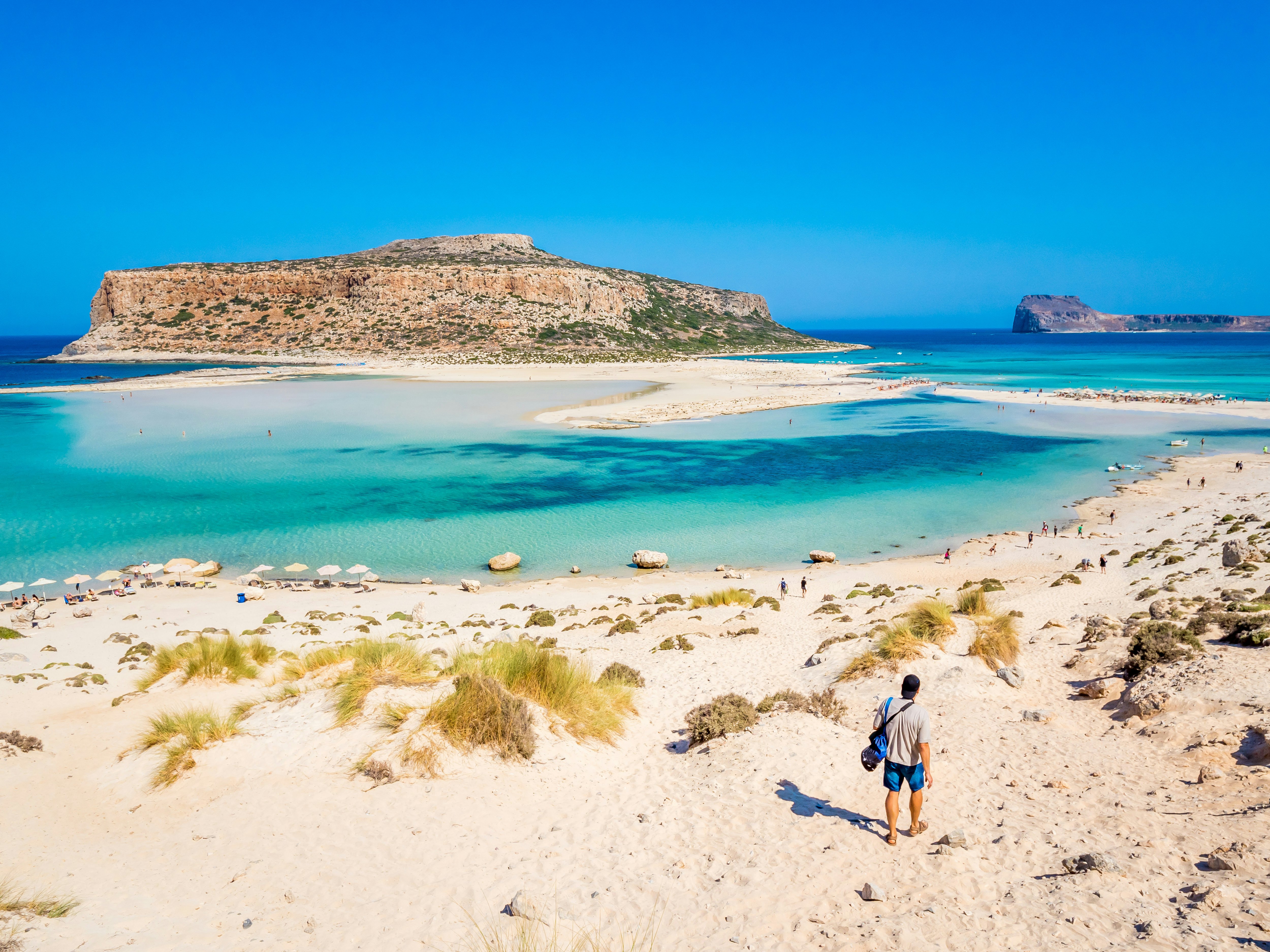 A man walks down to the water at Balos Lagoon.
1306866043
background, balos, bay, beach, blue, chania, coast, coastline, crete, crystal, destination, europe, freedom, fun, gramvousa, gramvoussa, greece, greek, happiness, happy, health, holiday, idyllic, island, lagoon, landmark, landscape, lifestyle, mediterranean, nature, outdoor, panorama, panoramic, paradise, relax, sand, scenic, sea, sightseeing, summer, sun, sunny, tourism, travel, trek, tropical, vacation, view, water, white