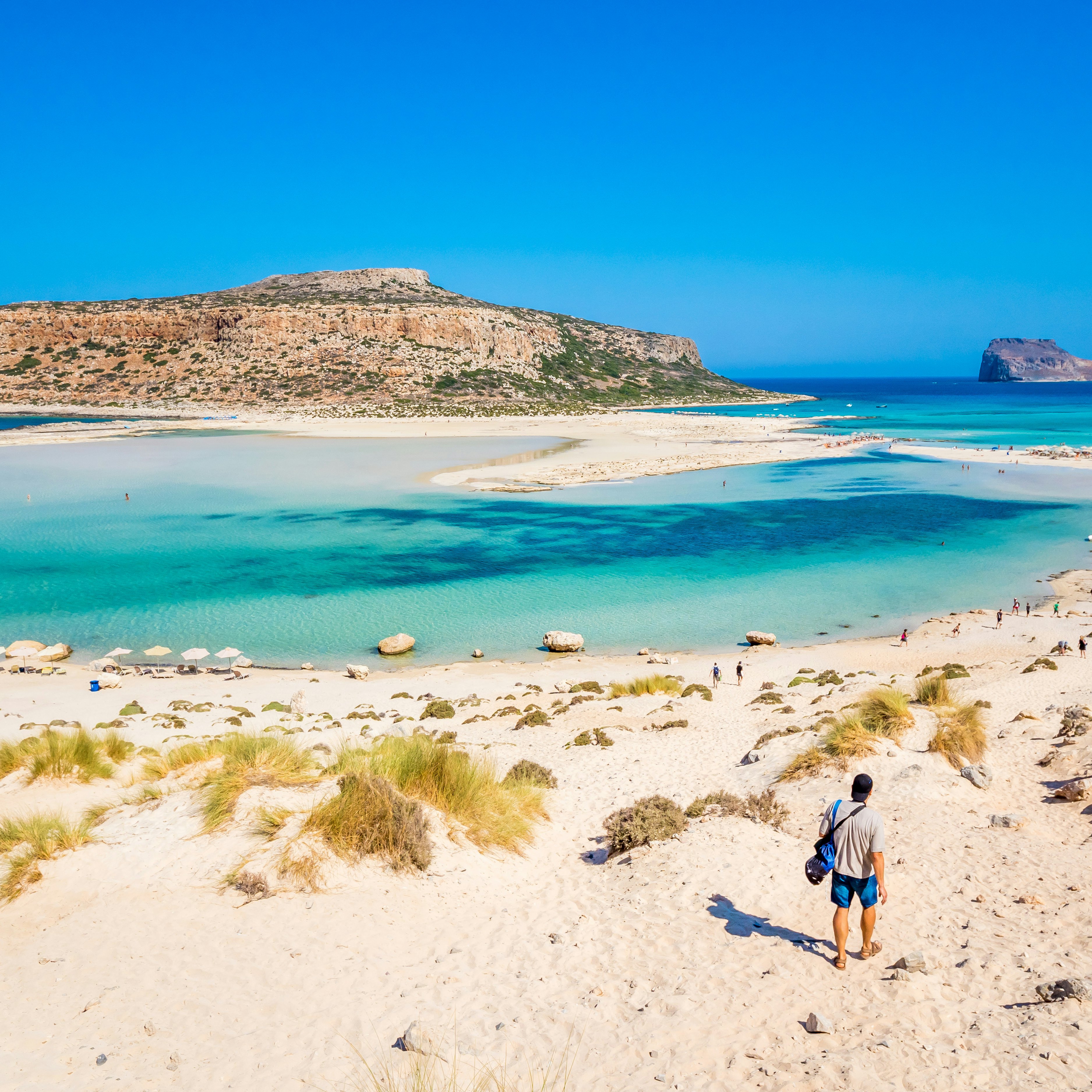 A man walks down to the water at Balos Lagoon.
1306866043
background, balos, bay, beach, blue, chania, coast, coastline, crete, crystal, destination, europe, freedom, fun, gramvousa, gramvoussa, greece, greek, happiness, happy, health, holiday, idyllic, island, lagoon, landmark, landscape, lifestyle, mediterranean, nature, outdoor, panorama, panoramic, paradise, relax, sand, scenic, sea, sightseeing, summer, sun, sunny, tourism, travel, trek, tropical, vacation, view, water, white