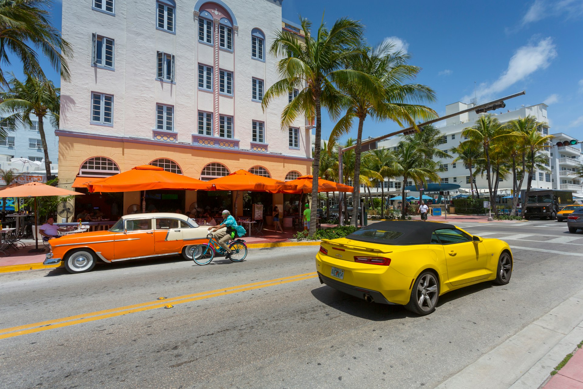 Vintage car & yellow cab on Ocean Drive in South Beach.