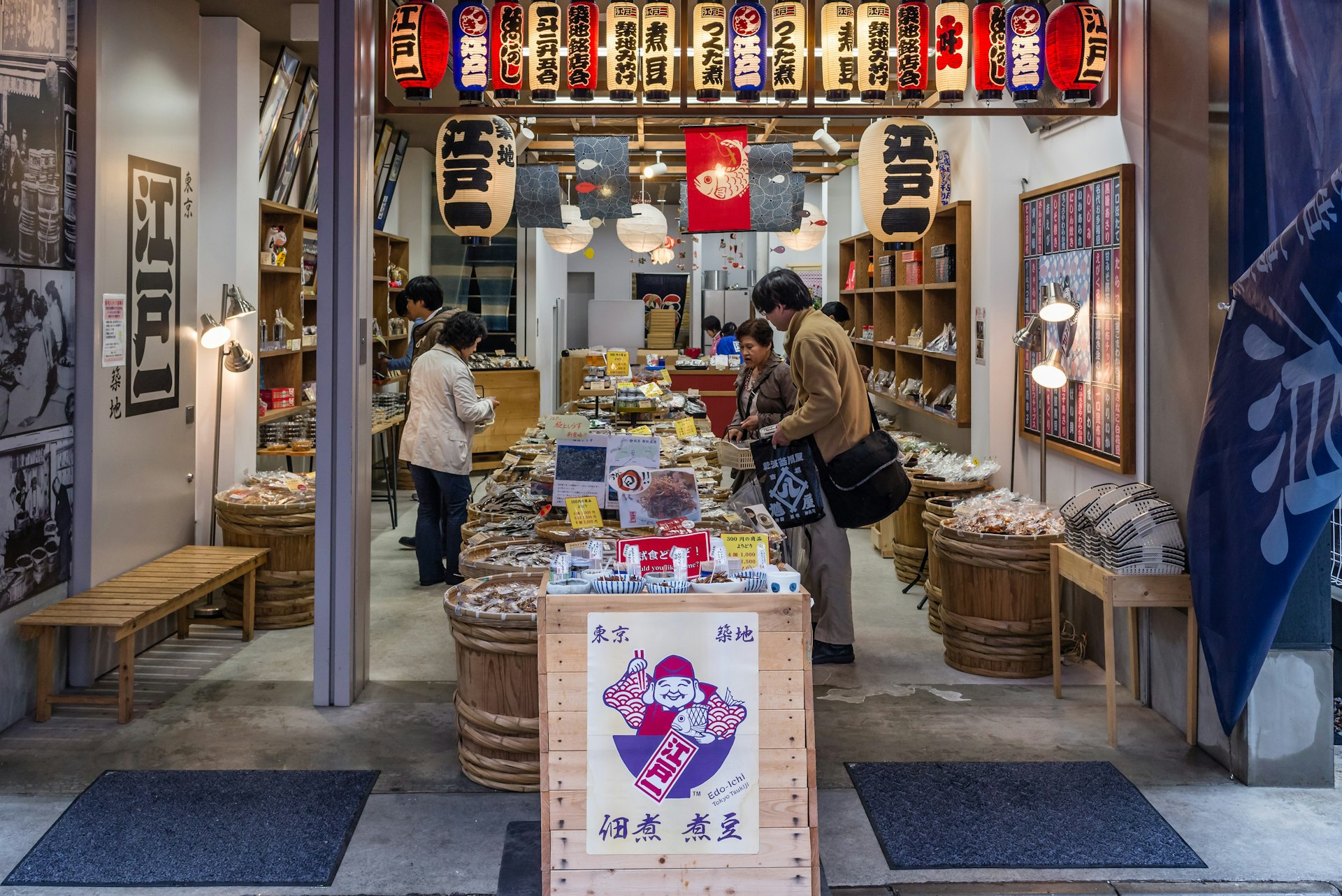 Shoppers browse and buy local products in one of the typical small shops located in the outer area of the Tsukiji Market, in Tokyo, Japan