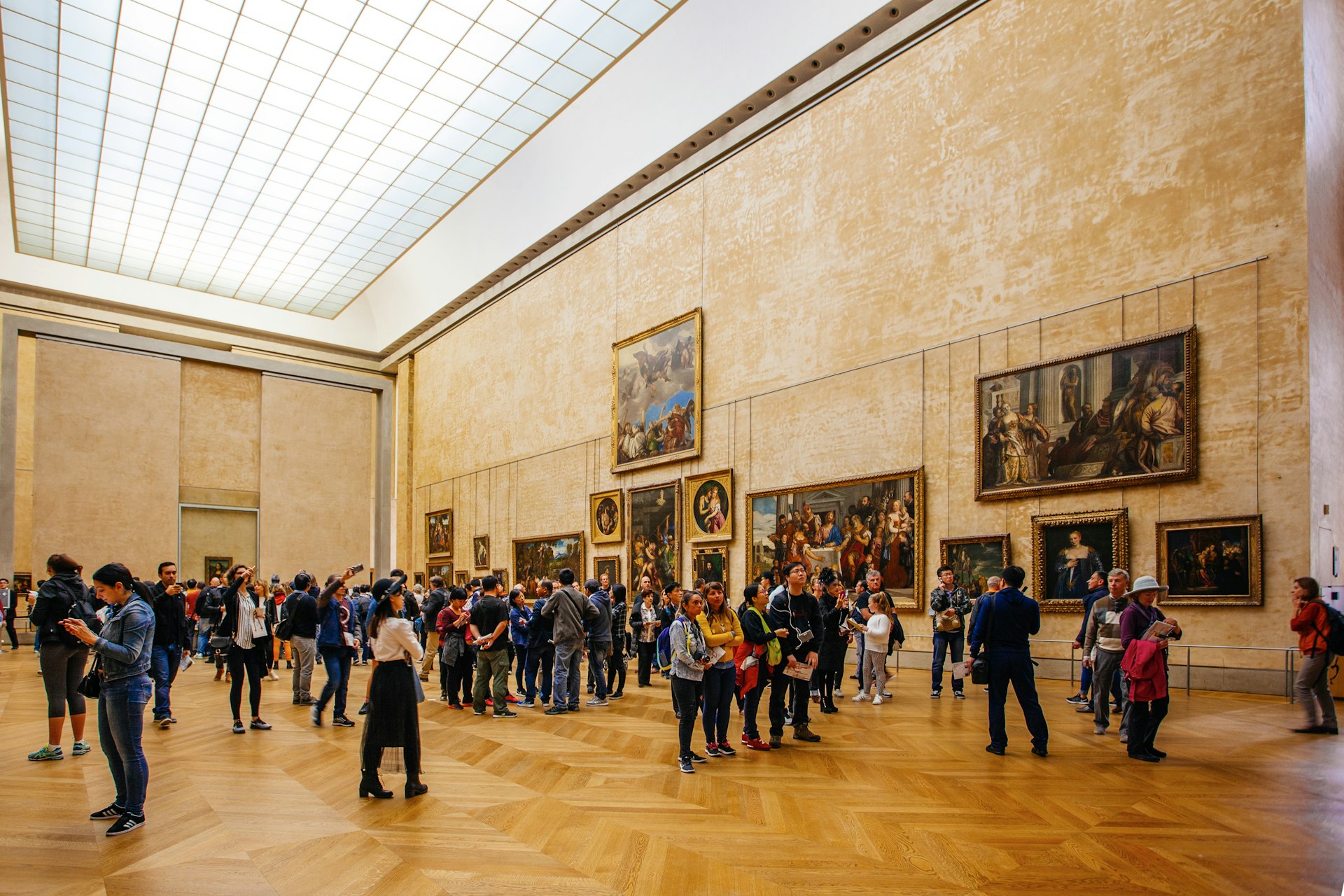 Tourists visit art gallery in the Louvre Museum.