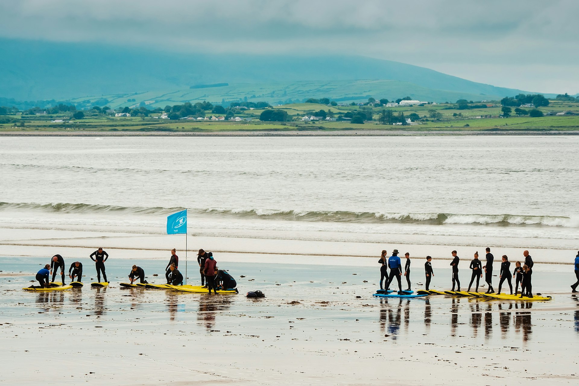 Two groups of teenagers having a surfing lesson on Strandhill Beach in County Sligo