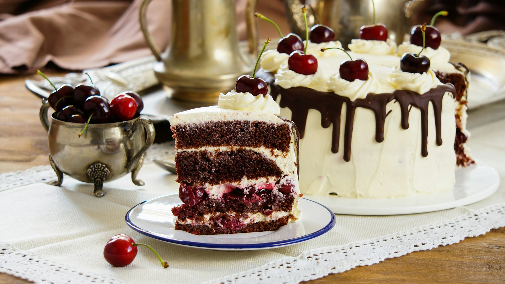 A cake with layers of chocolate sponge, cream, cherries, more chocolate and more cream