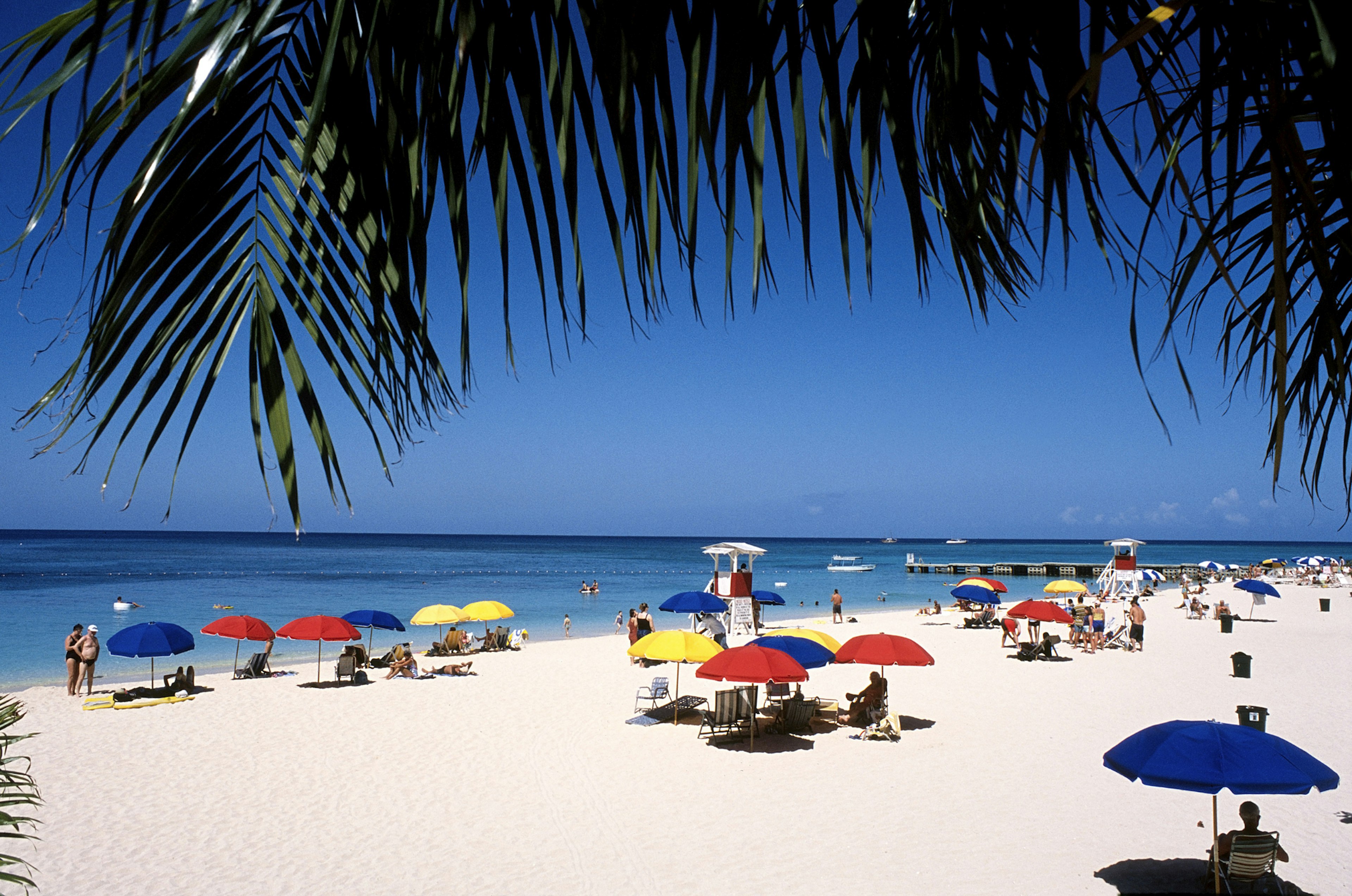 People relaxing at Doctor Cave Beach at Montego Bay in Jamaica.