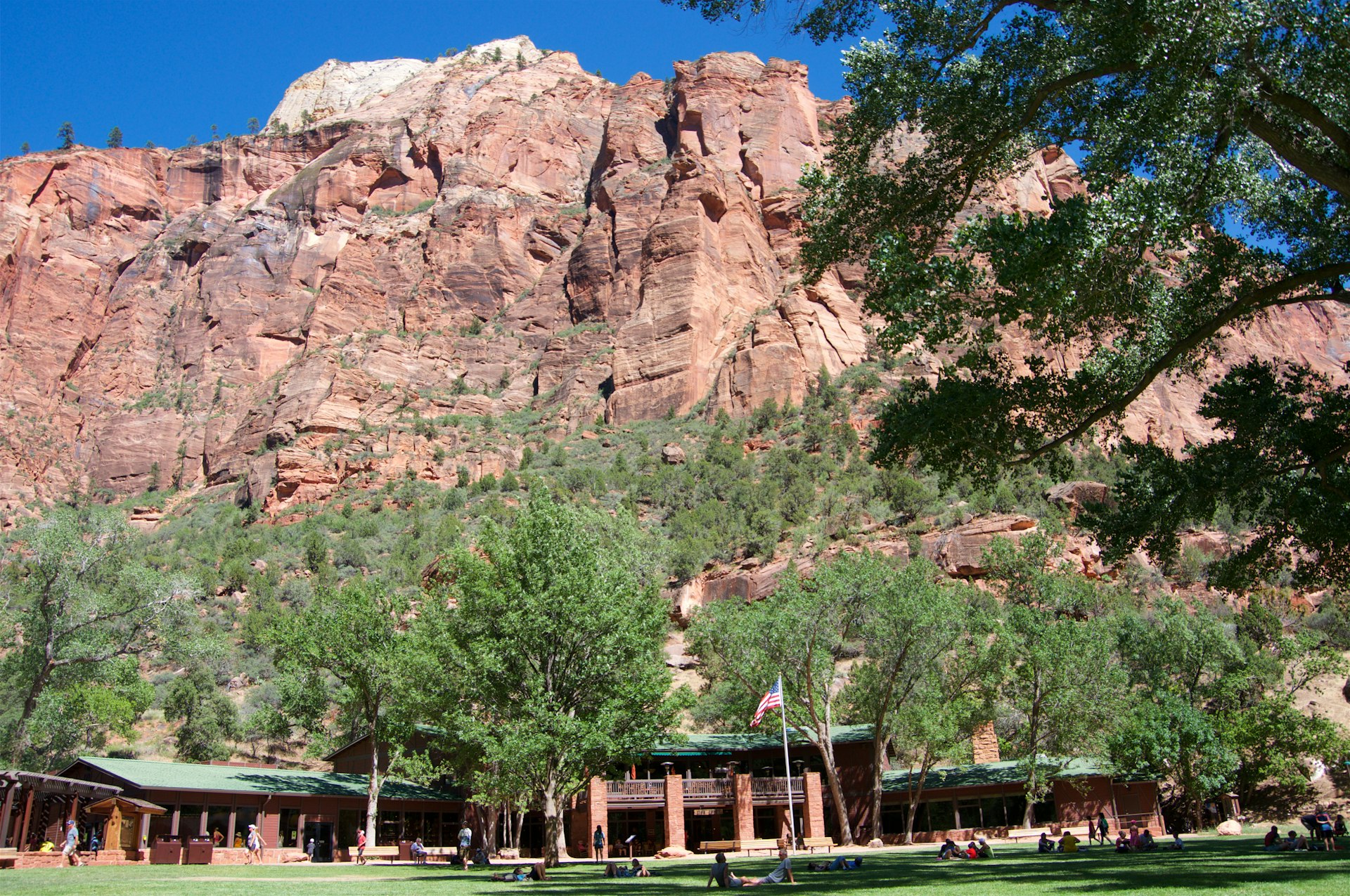 Low-angle view of tourists relaxing on the lawn of Zion Lodge at Zion National Park, Utah, USA