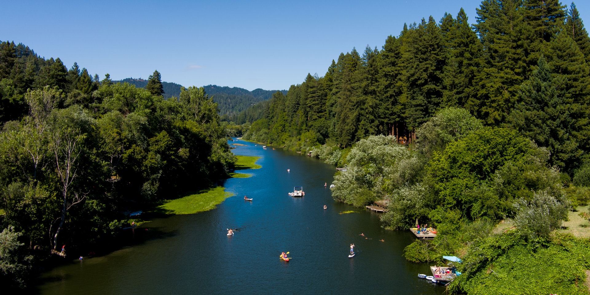 Kayaks, canoes and other water craft in the Russian River, near Guerneville, Sonoma County, California, USA