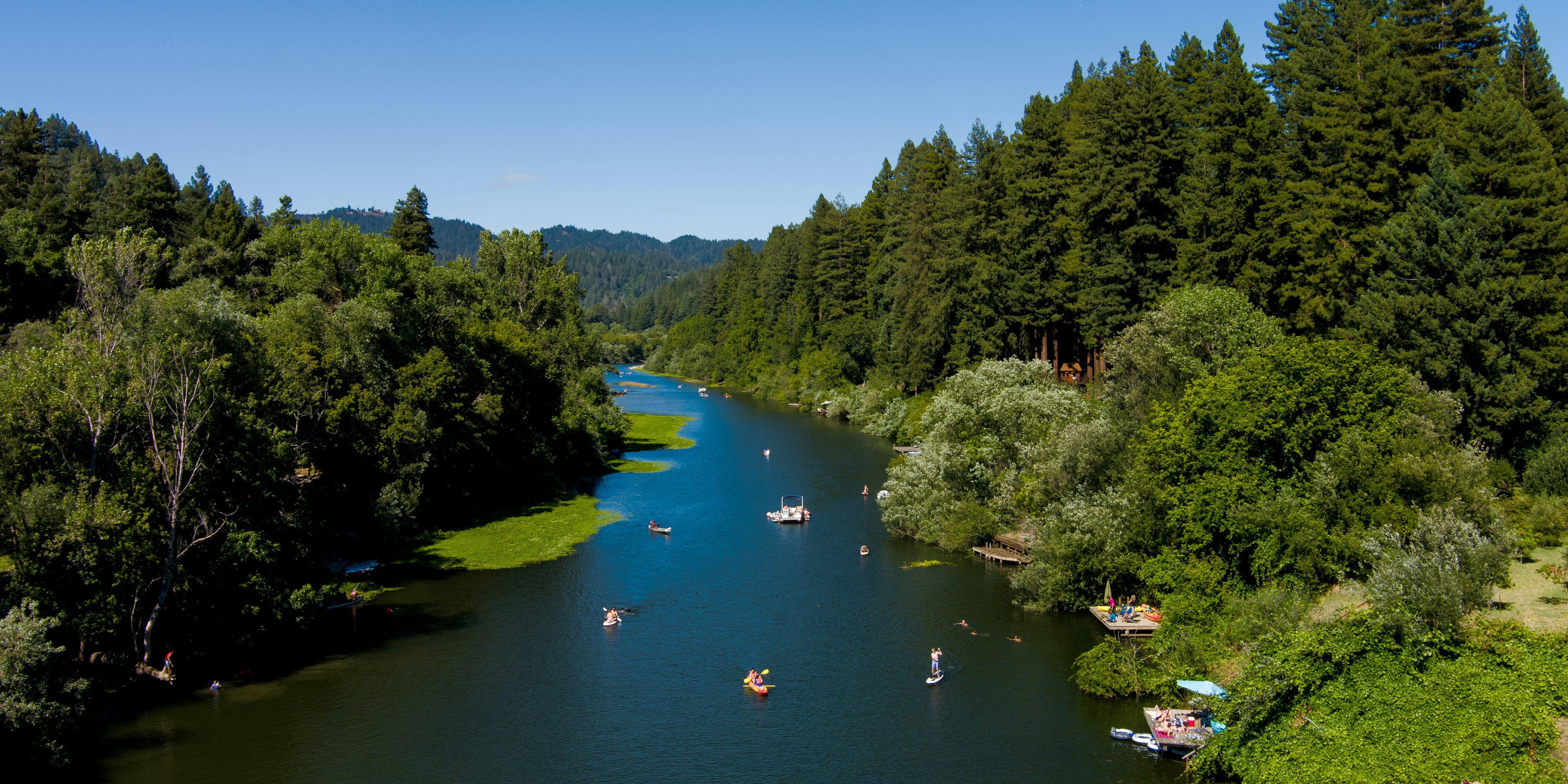 Kayaks, canoes and other water craft in the Russian River, near Guerneville, Sonoma County, California, USA