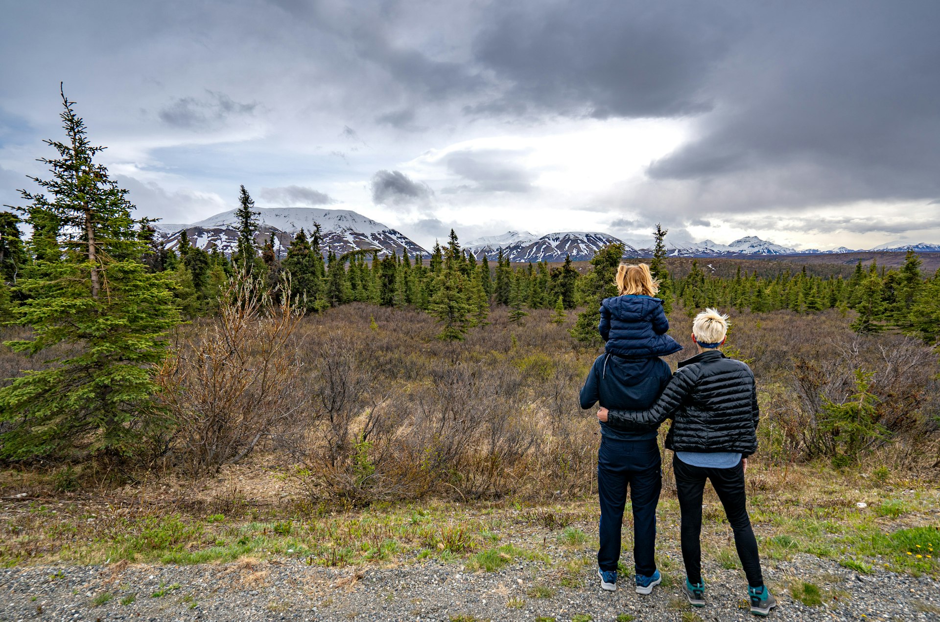 Two parents and a child enjoying the scenery at Denali National Park, Alaska