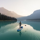 A young woman paddleboarding on Emerald Lake at sunrise in Yoho National Park.
1599827836