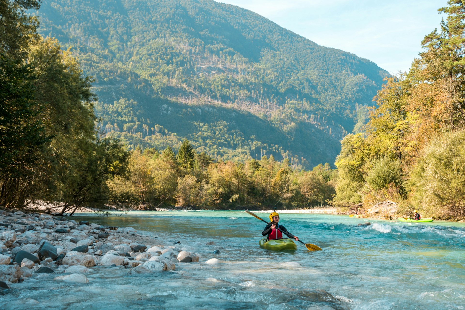A woman kayaking on the Soča River in Bovec, Slovenia
