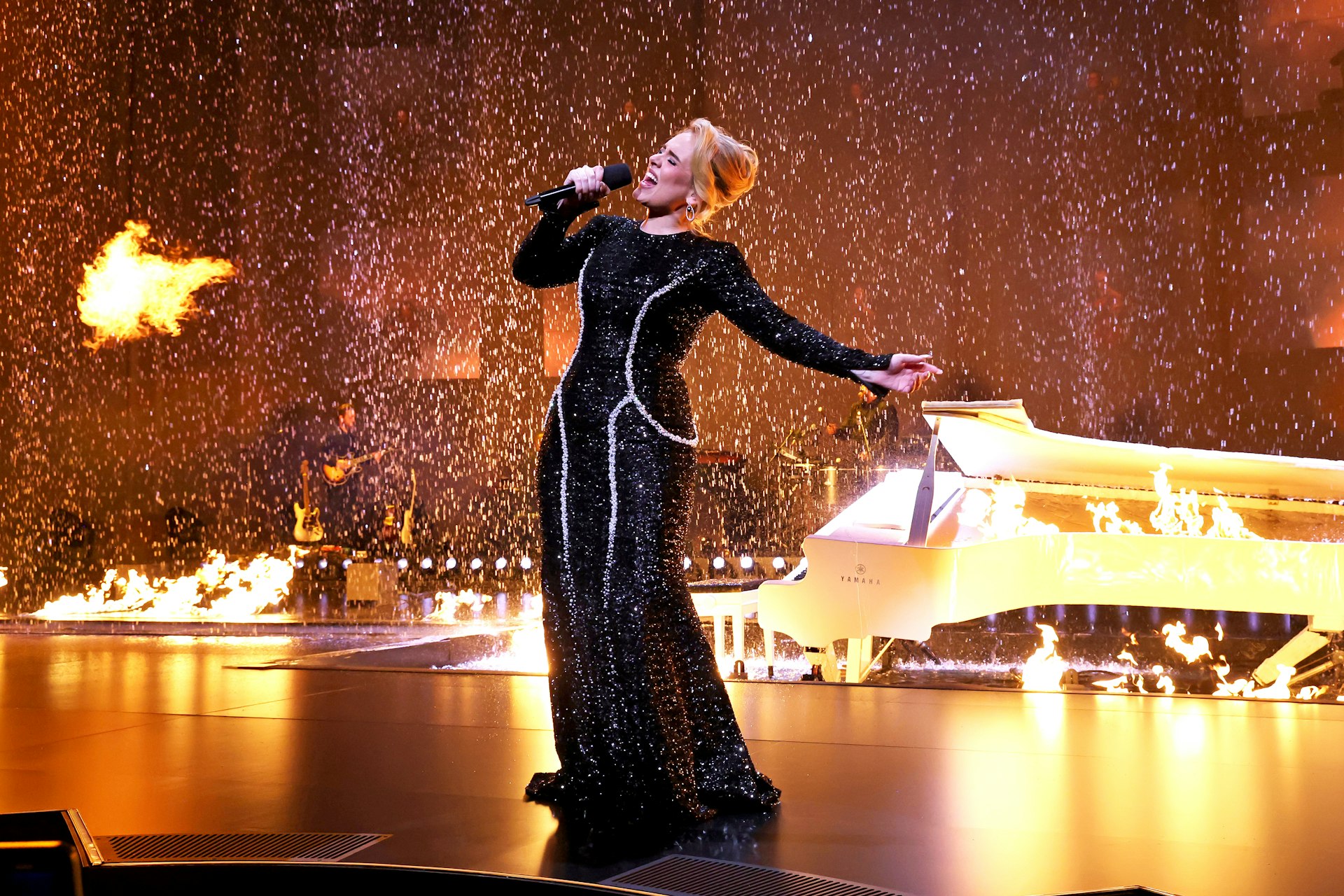 Adele performs in a black dress onstage at The Colosseum at Caesars Palace