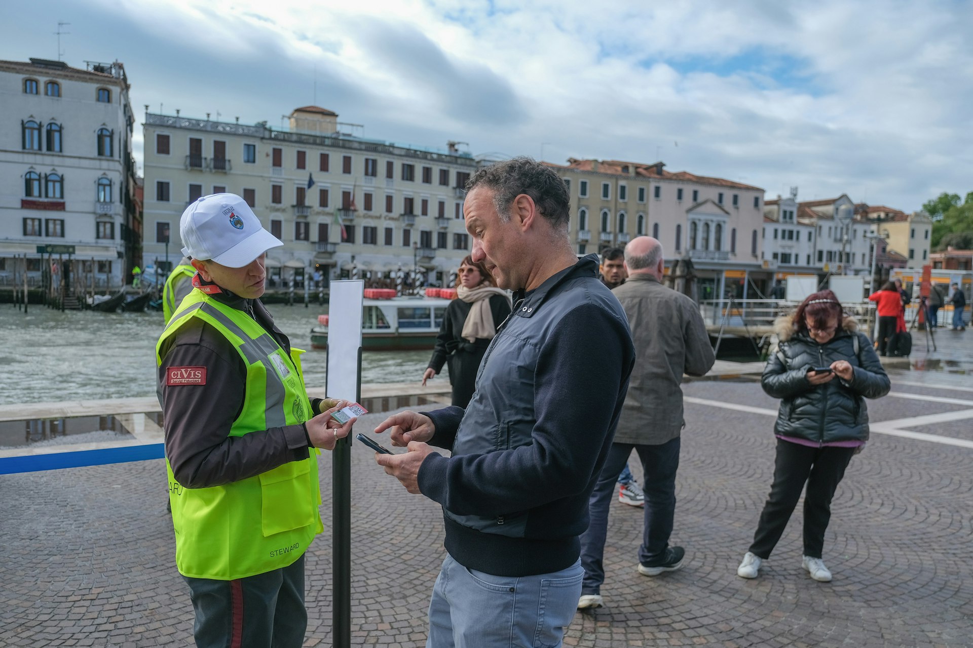 Steward check that tourists have purchased access tickets on April 25, 2024 in Venice, Italy
