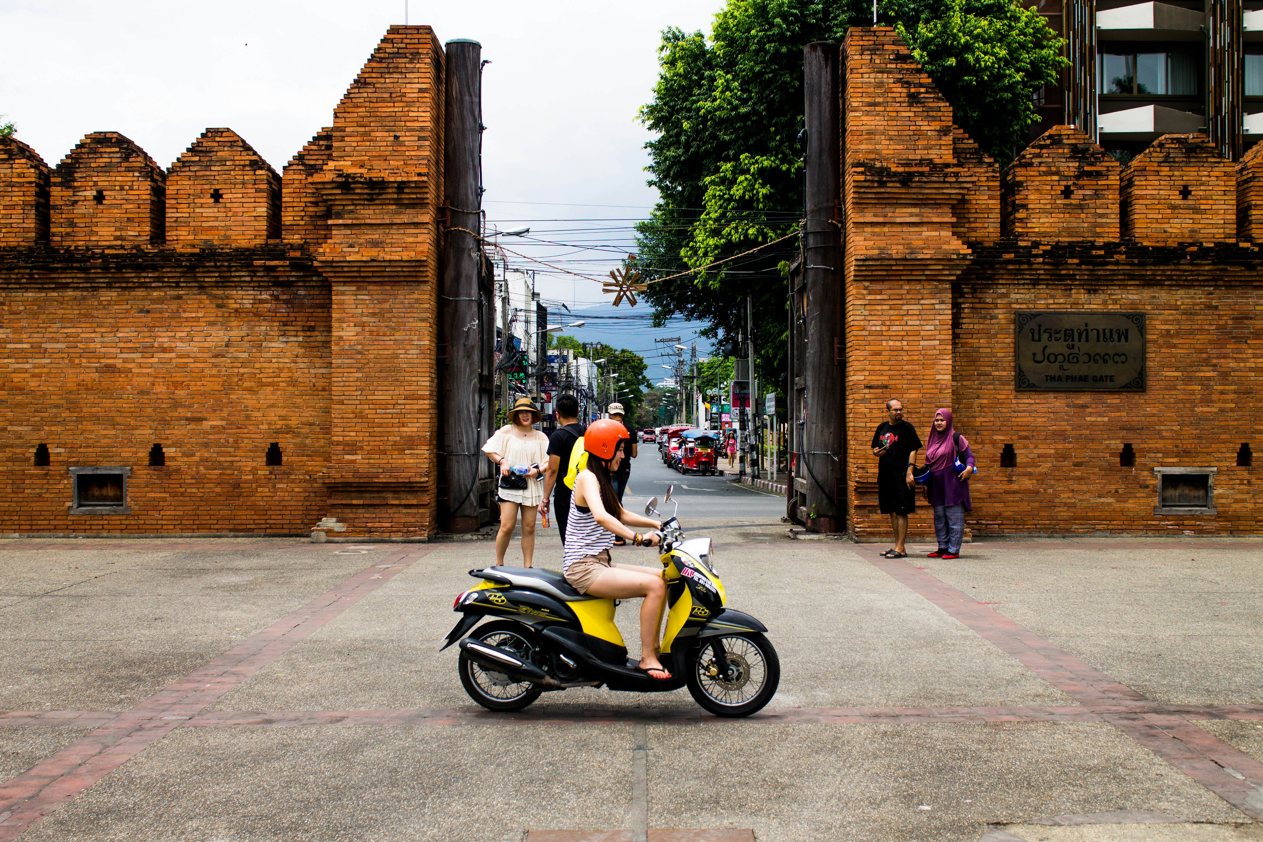 Chiang Mai, Thailand â€“ September 02, 2015: Group of tourists looking around the Thapae gate and one girl driving by them.
Chiang Mai, Thailand – September 02, 2015: Group of tourists looking around the Thapae gate and one girl driving by them.
486889596
Concrete Block, Concrete, Brownstone, Brick, Old Town, Chiang Mai Province, Thailand, Journey, Local Landmark, International Landmark, Famous Place, Tourist, Asia, Gate, Paver Brick, Quoin, Thapae
Thailand-Chiang Mai Province-Chiang Mai City-HoneyBee201306-GettyImages-486889596-RFE
Chiang Mai, Thailand – September 02, 2015: Group of tourists looking around the Thapae gate and one girl riding by on a moped © HoneyBee201306 / Getty Images