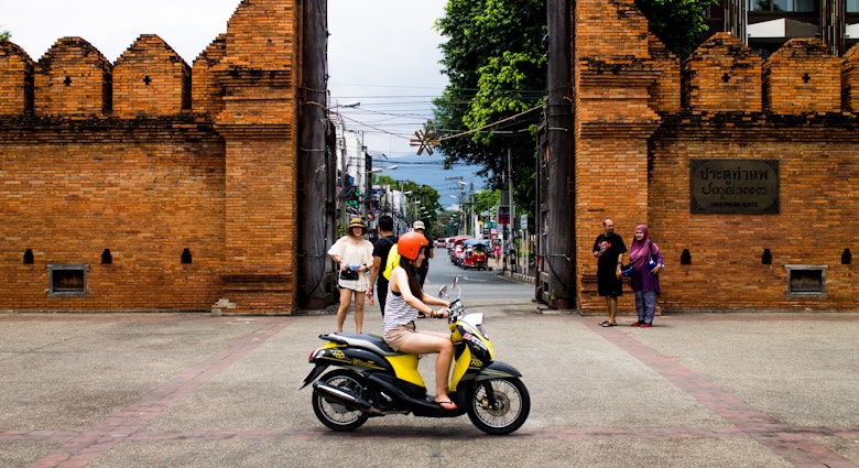 Chiang Mai, Thailand â€“ September 02, 2015: Group of tourists looking around the Thapae gate and one girl driving by them.
Chiang Mai, Thailand – September 02, 2015: Group of tourists looking around the Thapae gate and one girl driving by them.
486889596
Concrete Block, Concrete, Brownstone, Brick, Old Town, Chiang Mai Province, Thailand, Journey, Local Landmark, International Landmark, Famous Place, Tourist, Asia, Gate, Paver Brick, Quoin, Thapae
Thailand-Chiang Mai Province-Chiang Mai City-HoneyBee201306-GettyImages-486889596-RFE
Chiang Mai, Thailand – September 02, 2015: Group of tourists looking around the Thapae gate and one girl riding by on a moped © HoneyBee201306 / Getty Images
