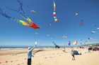 Lincoln City, Oregon,USA- June 26, 2016: Annual kite festival in Linclon City on the Oregon Coast.  A man and boy play with paddles and ball on sandy beach under a sky full of kites.
546008220
Editorial, Boys, Men, Coastline, Playing, Fun, Hat, Yellow, Red, Purple, Pink Color, Orange Color, Green Color, Blue, Sport, Outdoors, People, Oregon, Pacific Northwest, Sand, Beach, Sky, Wind, Sea, Wave, Water, Flag, Traditional Festival, Kite - Toy, Ball, Shorts, Lincoln City - Oregon