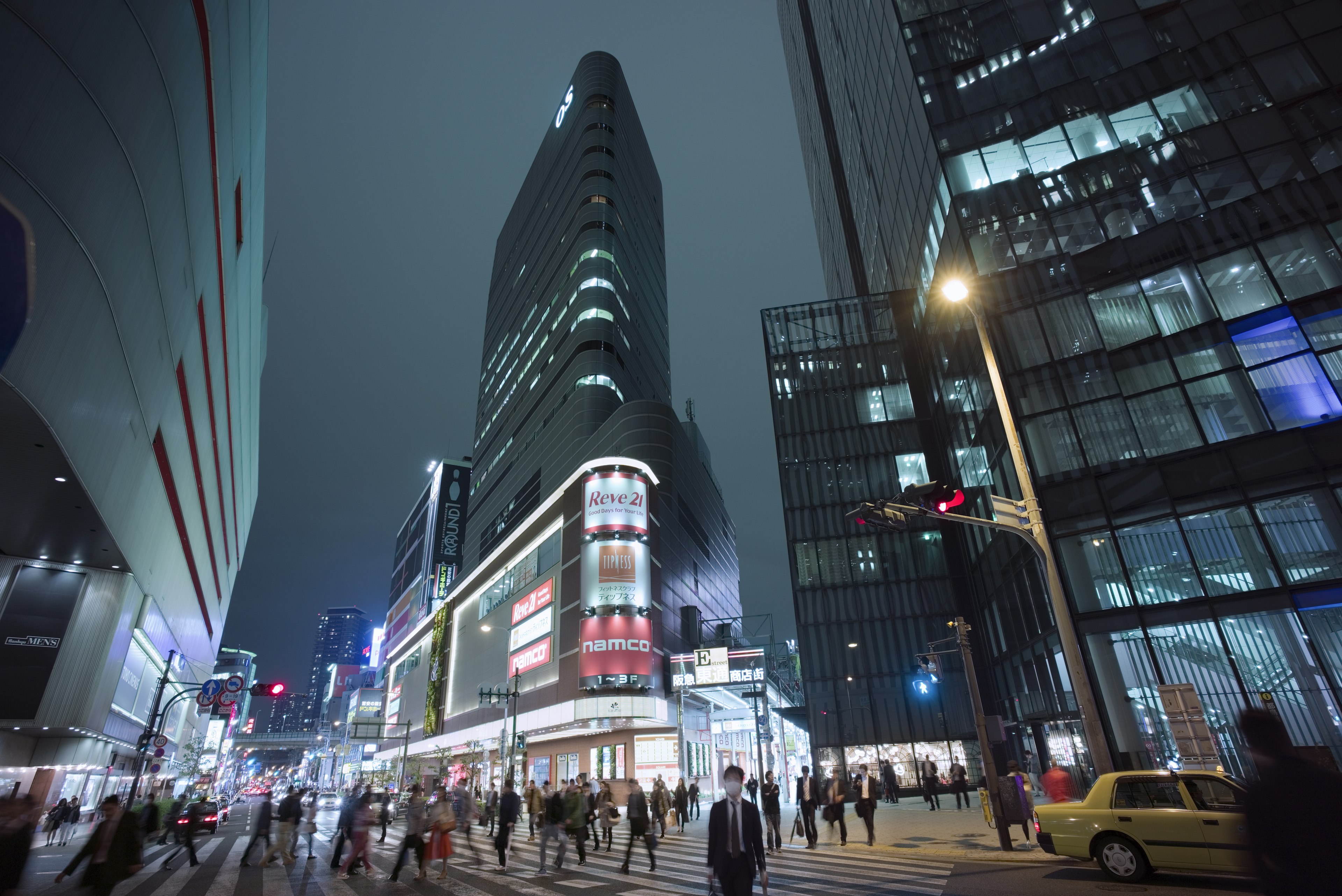 People on the sidewalk in the busy neighborhood of Umeda, Osaka, Japan