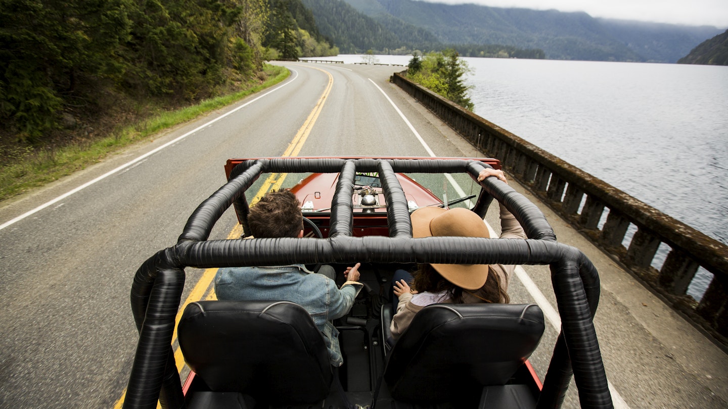 A couple speeding along a two lane road in their convertible jeep.
641335541
Jeep, convertible, driving, friendship, road trip