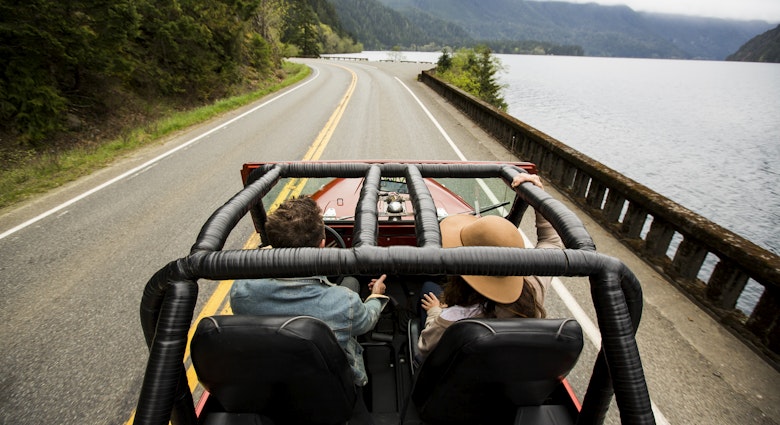 A couple speeding along a two lane road in their convertible jeep.
641335541
Jeep, convertible, driving, friendship, road trip
