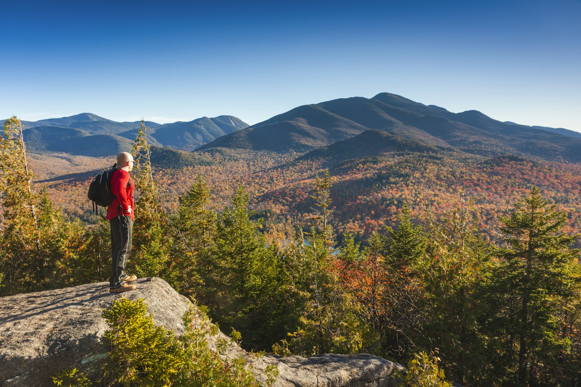 A hiker in fall in the Adirondack Mountains, New York State, USA