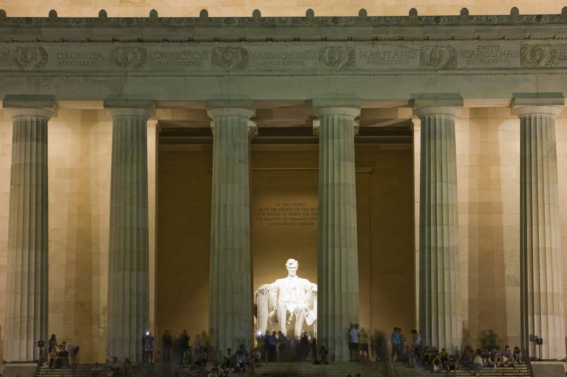 Tourists on the steps of the Lincoln Memorial at night, Washington, DC, USA