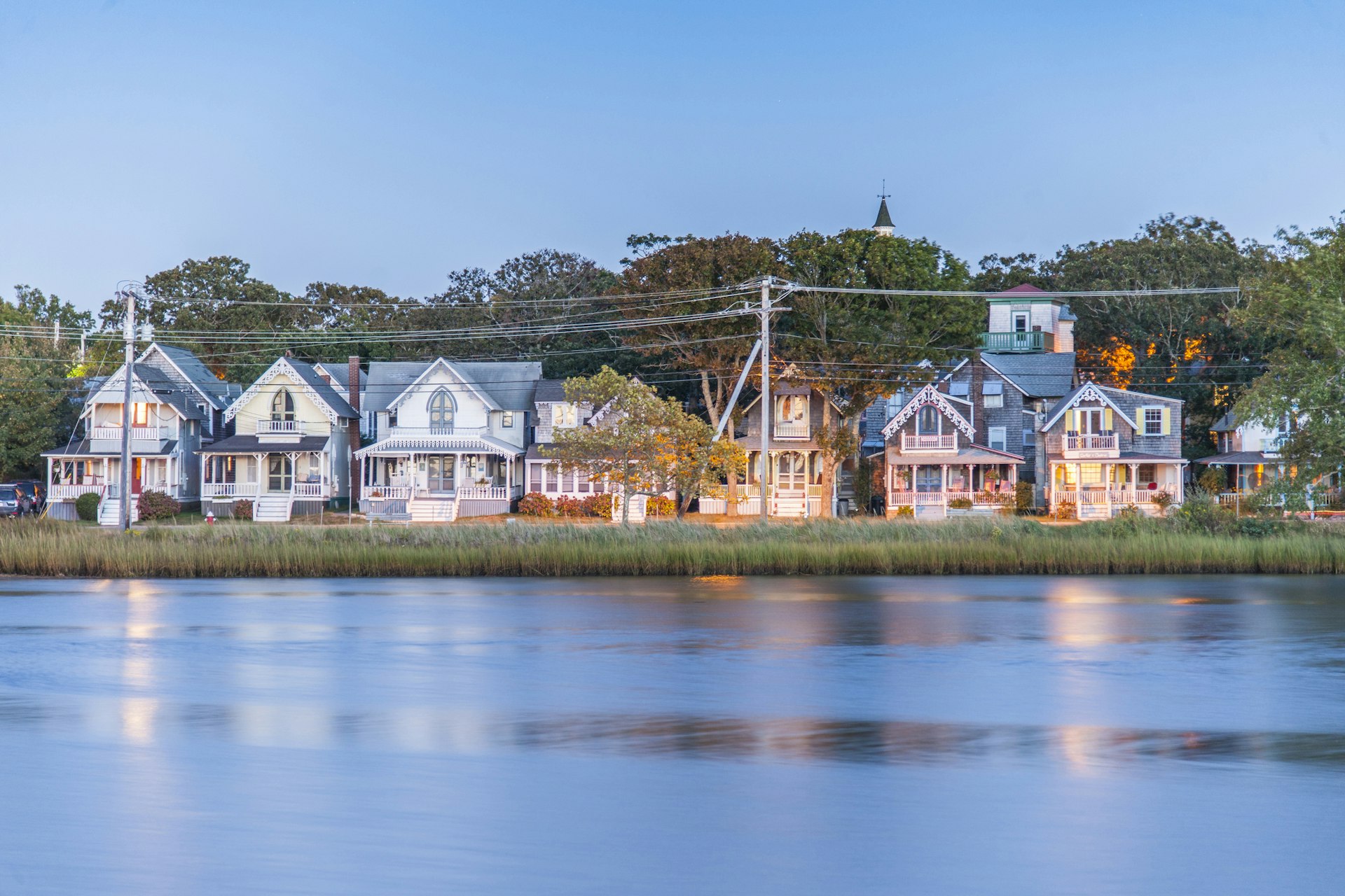 A row of large pastel-colored wooden houses faces the waterfront