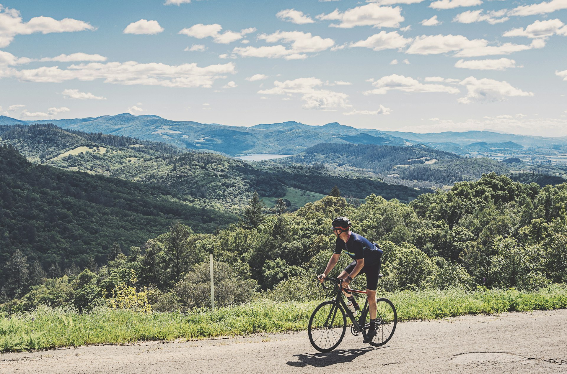 A man bicycling on a hilly road in Napa, California, USA