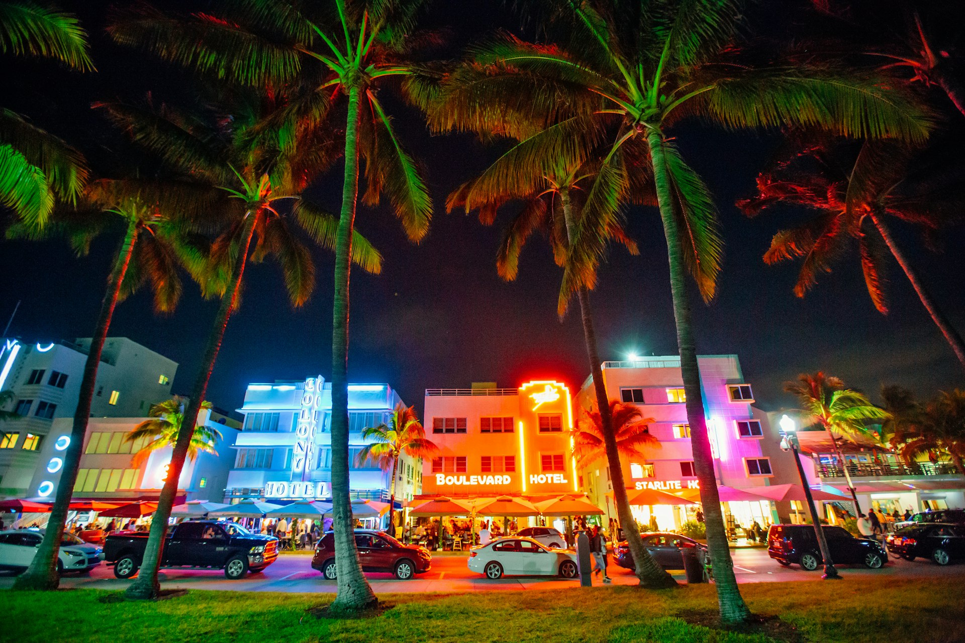 Carros ao longo da Ocean Drive à noite, Miami Beach, Flórida, EUA