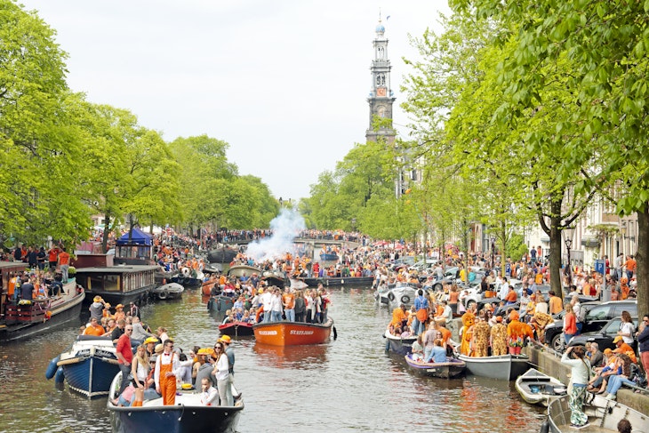 Amsterdam The Netherlands - April 26, 2014: Amsterdam canals full of boats and people in orange at the Prinsengracht during the celebration of kings day on April 26, 2014 in Amsterdam, The Netherlands
520265305
Capital Cities, Holiday, Tourist, Passenger Craft, Built Structure, Holiday - Event, Looking At View, Cruise Ship, King - Royal Person, Party - Social Event, Queen, Medieval, King's Day, Cityscape, Architecture, King's Day - Netherlands, April, city-view, Party, Amsterdam, City, Canal, Horizontal, Queen - Royal Person, Water, Canal House, Netherlands, Celebration, House, Day, Building Exterior, Cruise - Vacation, King, Residential Building, People, Photography, Queens-day, City-scenic, Outdoors, River, Nautical Vessel