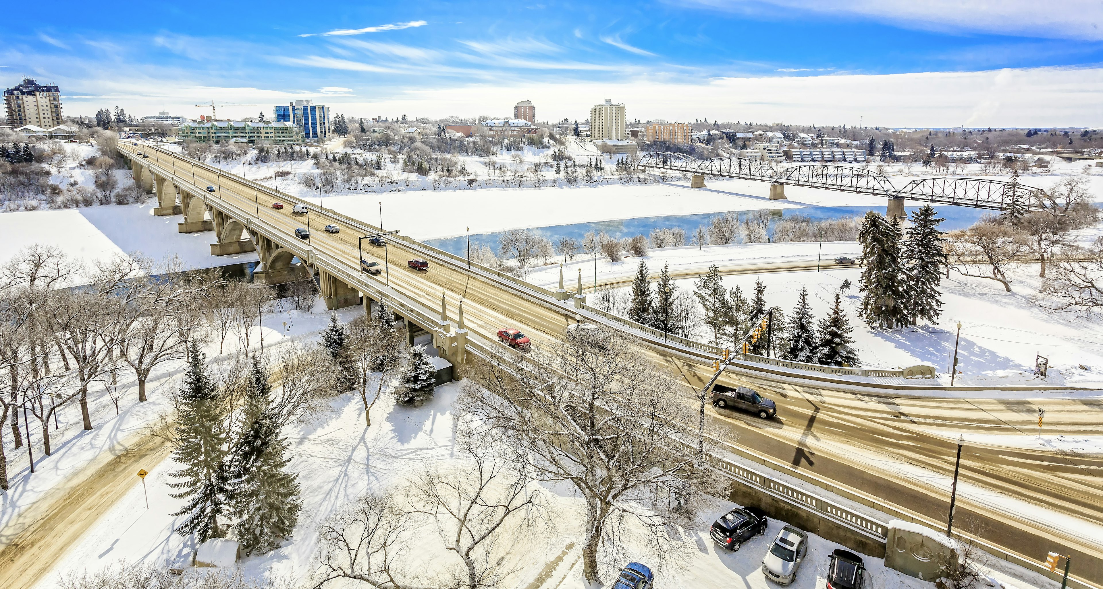 A riverside city in winter with snow covering the roads and bridges