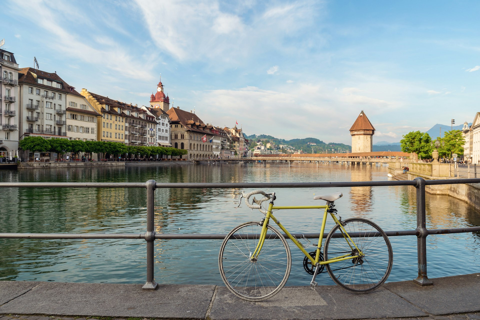 Bicycle in historic city center of Lucerne with famous Chapel Bridge with blue sky and clouds in Lucerne, Switzerland 
