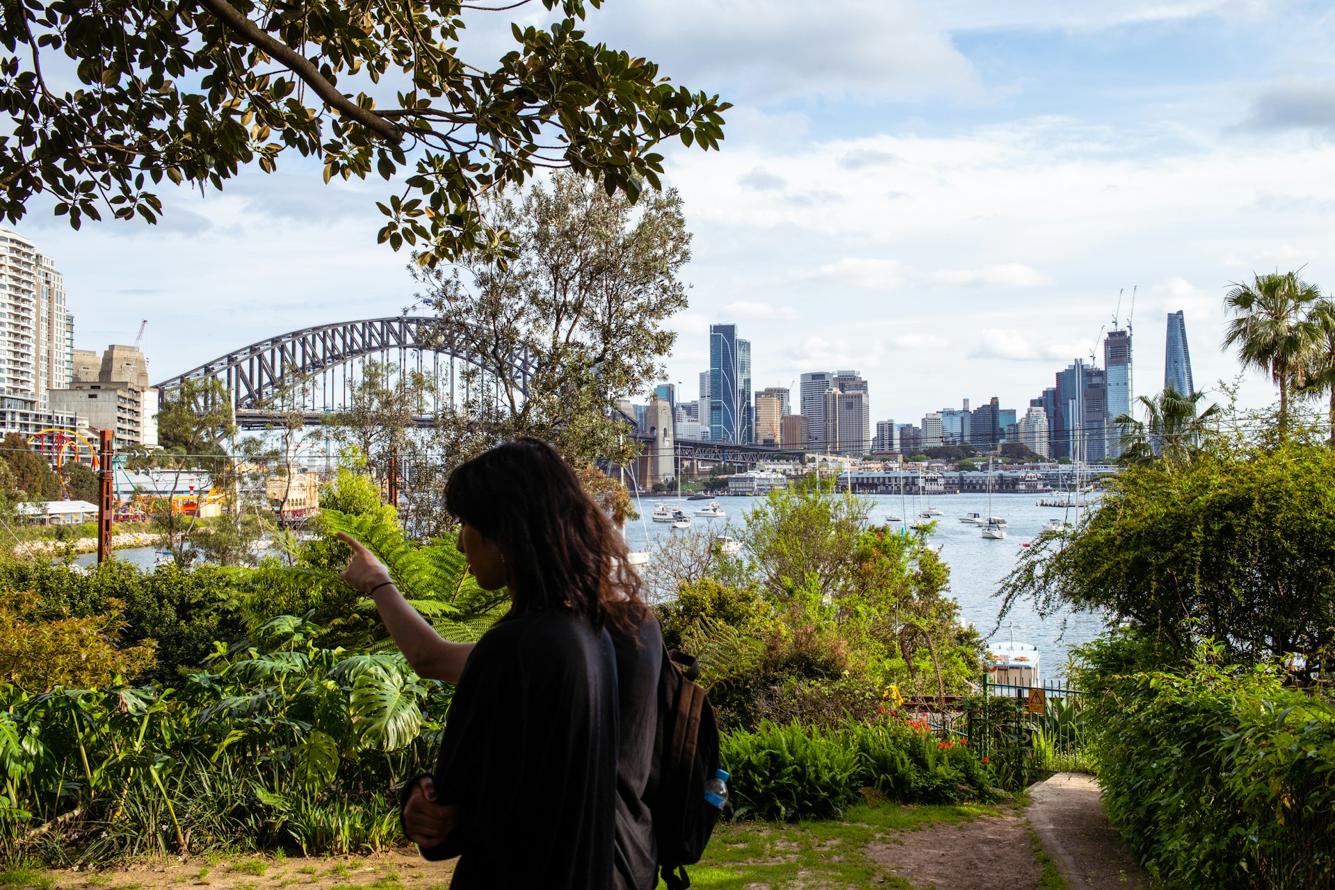 People in Wendy’s Secret Garden with the Harbour Bridge and skyline in the distance, Sydney, New South Wales, Australia