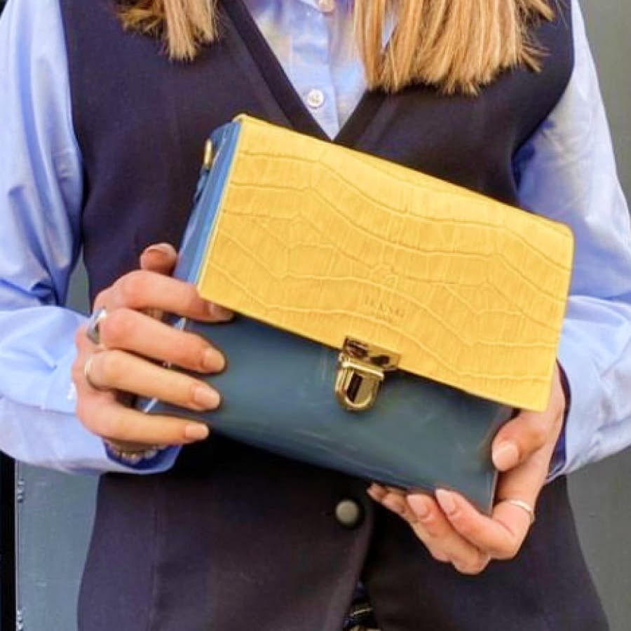 Hands holding an Italian leather bag