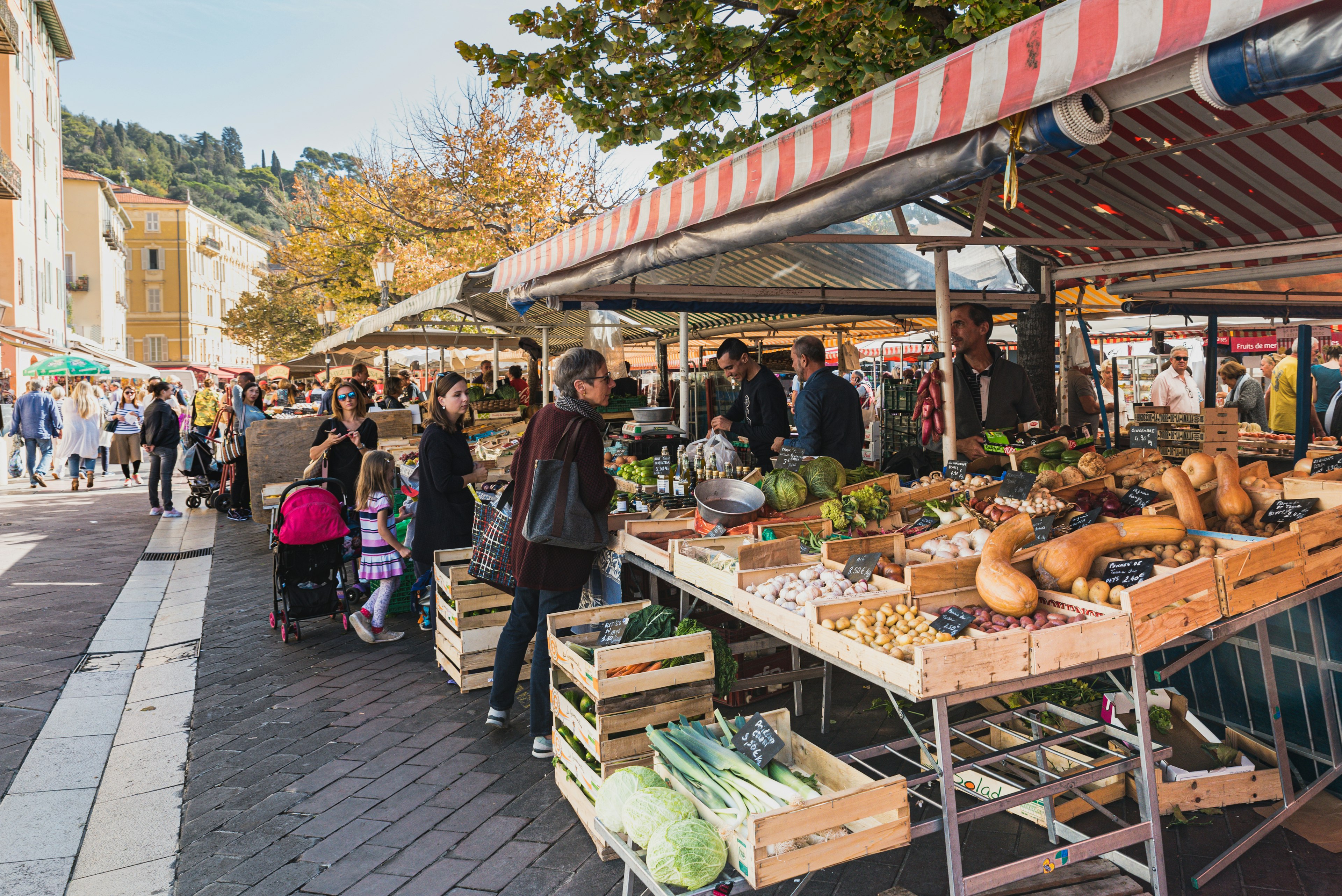 The famous Marche Aux Fleurs Cours Saleya in Place Charles Felix in Nice. Fresh fruits and colourful vegetables lie on the stands