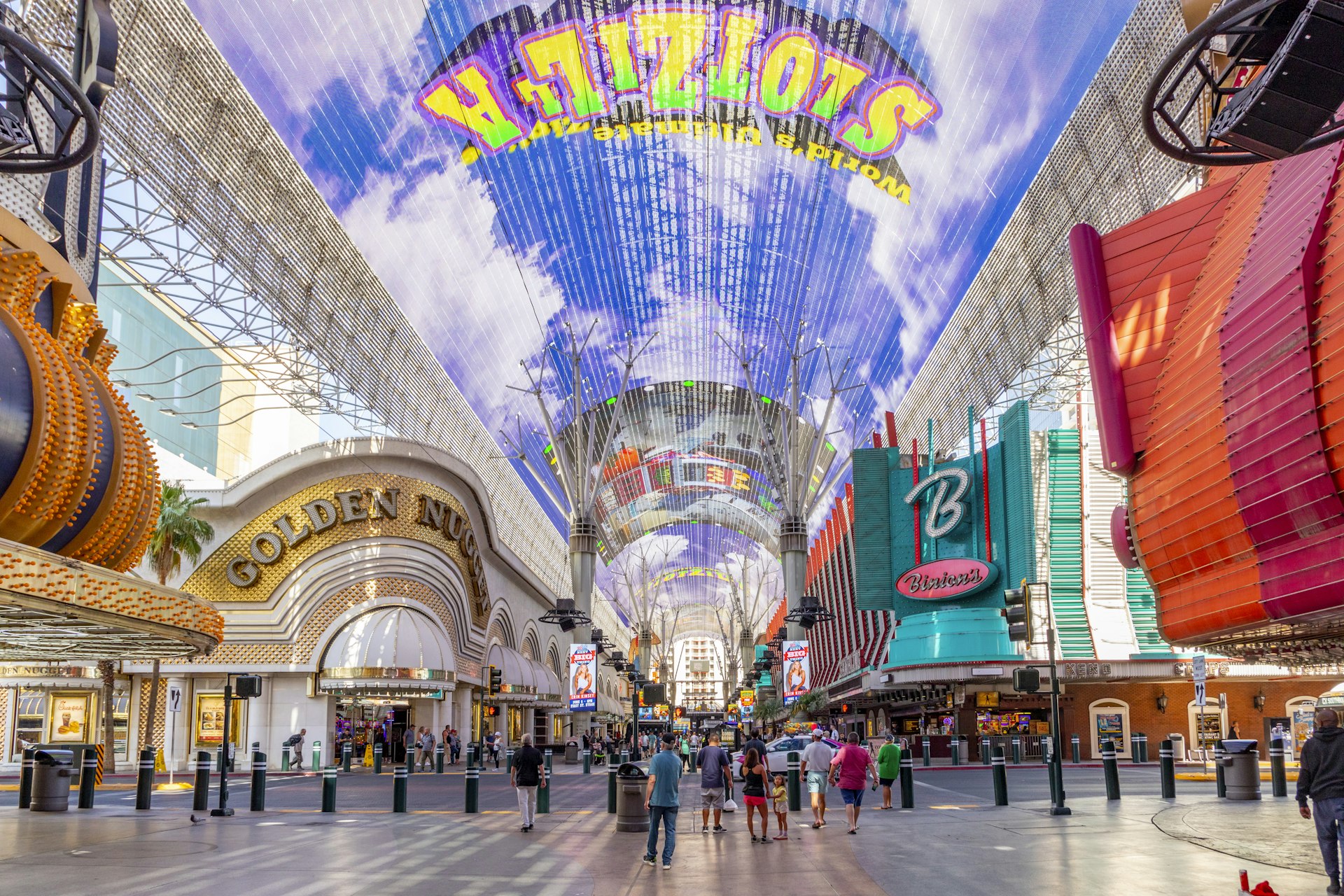 Hustle and bustle of crowds during the day on the famous Fremont Street in the heart of downtown Las Vegas with its casinos, neon lights and street entertainment.