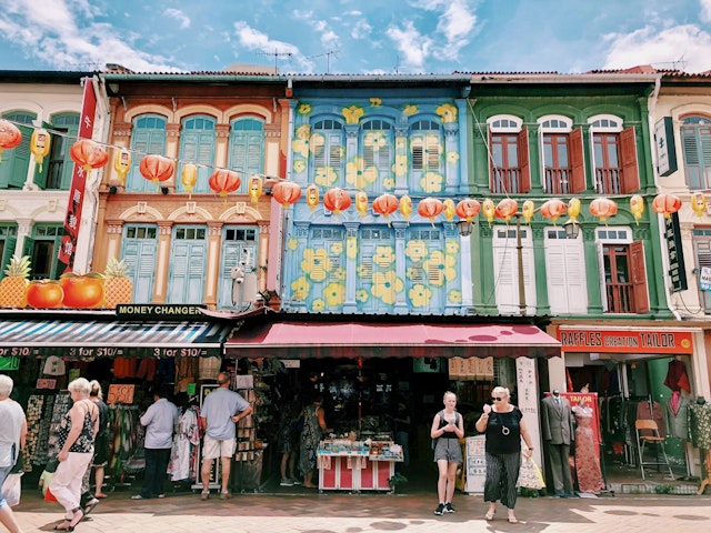Old street front in Singapore's Chinatown with tourists