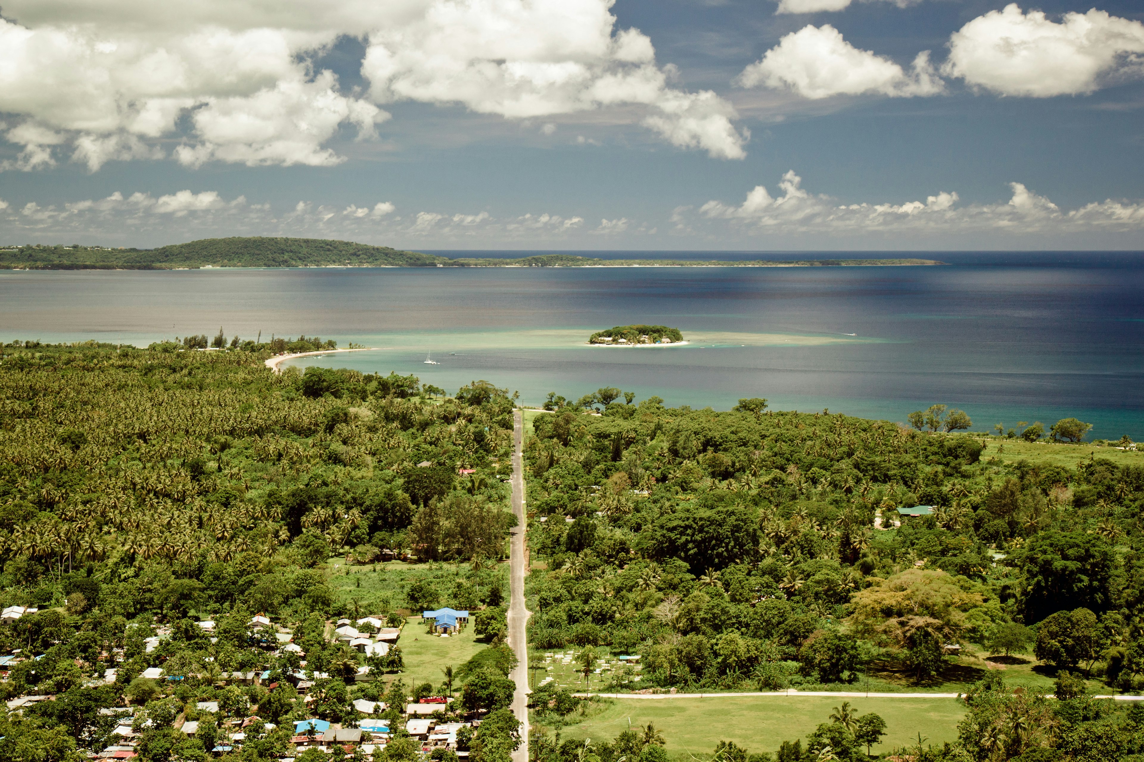 A settlement surrounded by foliage on the edge of the sea