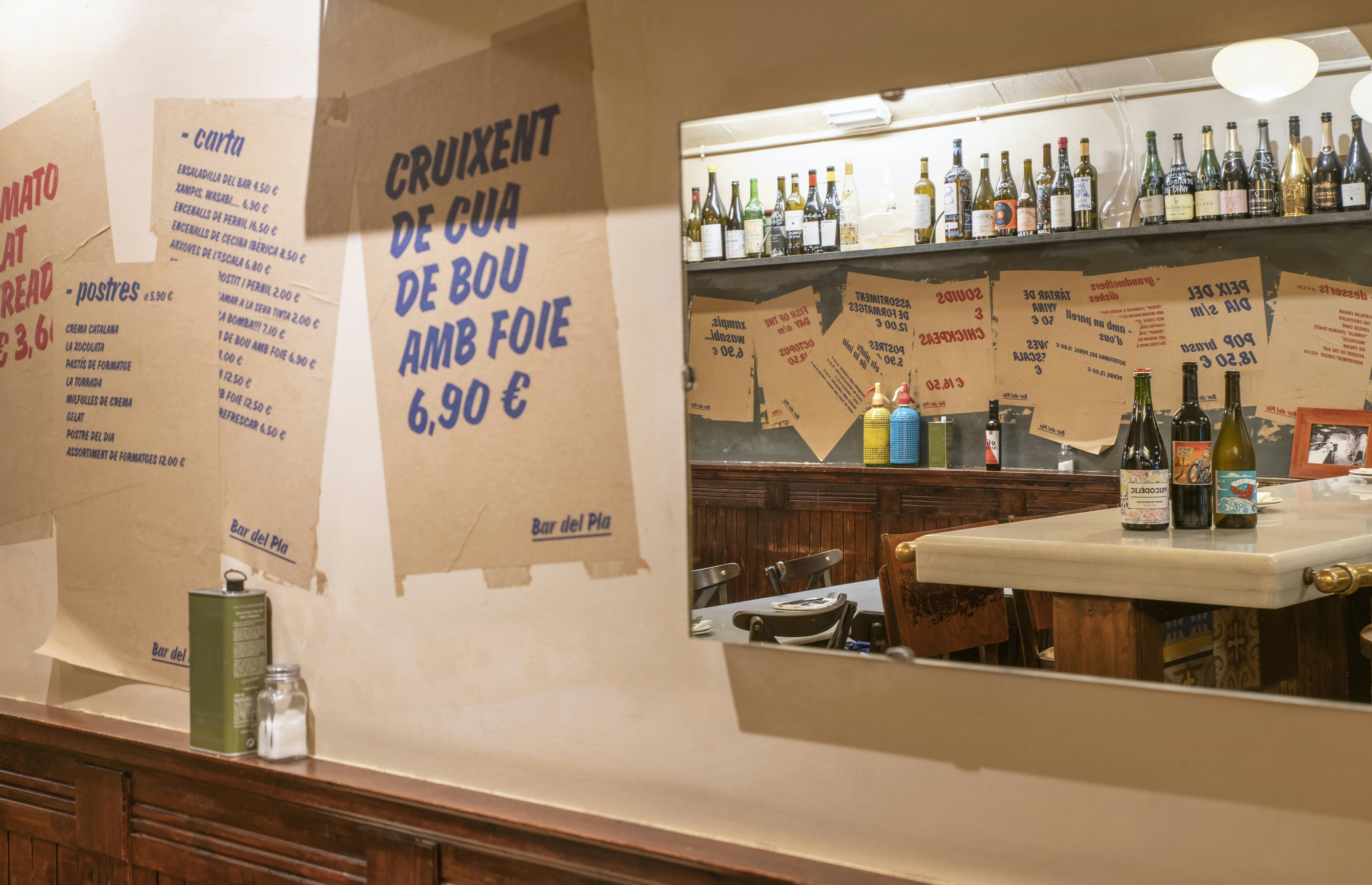 Interior of Bar del Pla, Barcelona, where printed menus decorate the walls