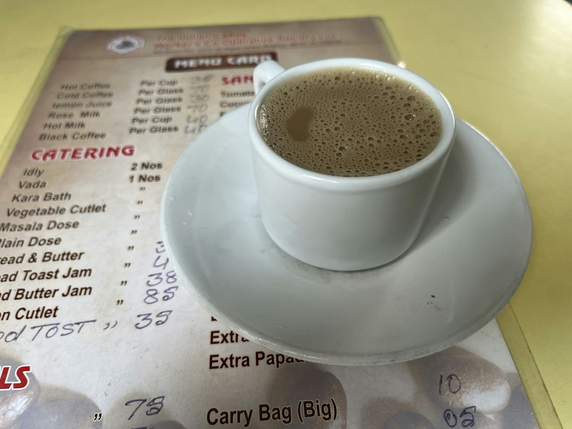 A filter coffee in a cup with saucer placed on a menu