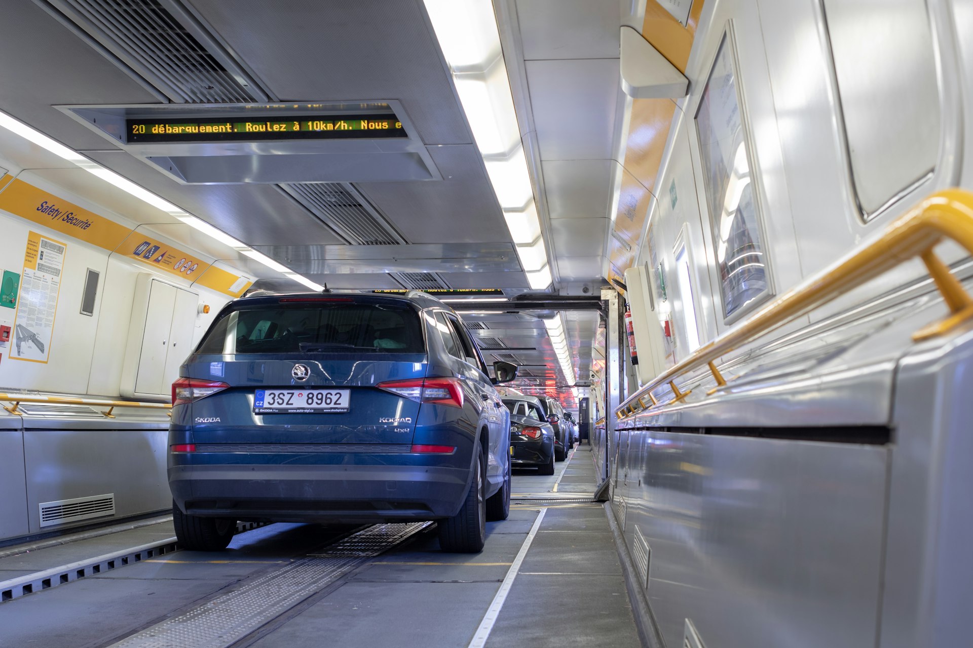 Cars lined up bumper to bumper inside a Eurotunnel train