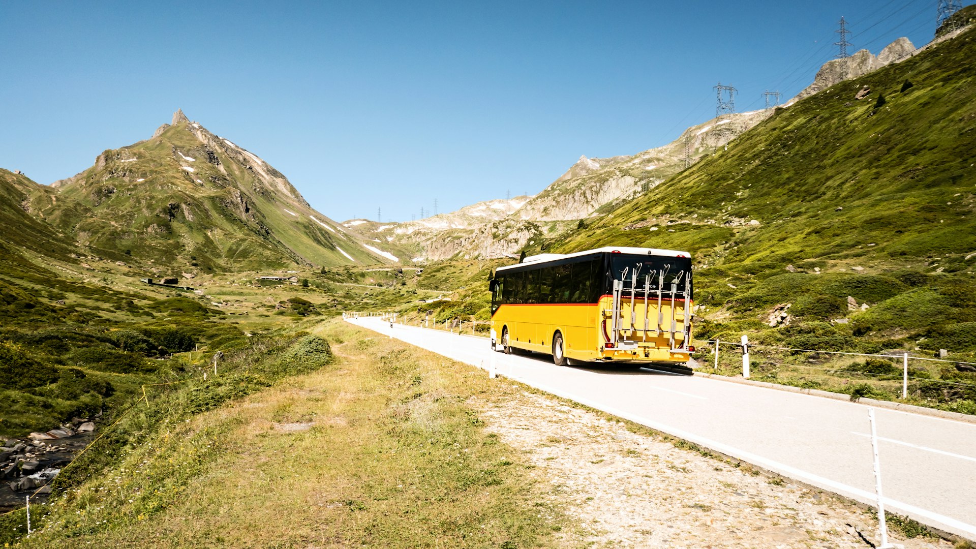 A yellow PostBus in Nufenen Pass between Ticino and Valais, Switzerland