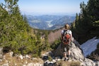 A woman standing at the viewpoint on the slope of Ratitovec in Julian Alps, Slovenia