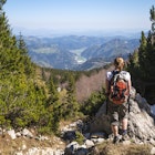 A woman standing at the viewpoint on the slope of Ratitovec in Julian Alps, Slovenia