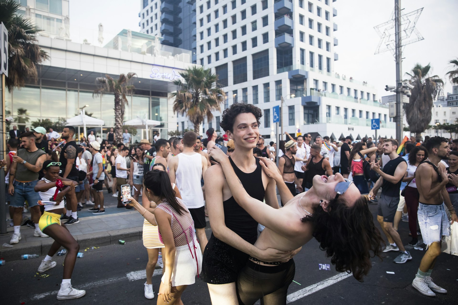 Young people dance in the streets during the Pride celebrations in Tel Aviv, Israel