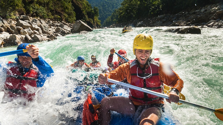 Rafters get splashed as they go through some big rapids on the Karnali river in Nepal - stock photo
The Karnali river in west Nepal is one of the wildest rivers for rafting and kayaking in the world with some Grade 5 rapids