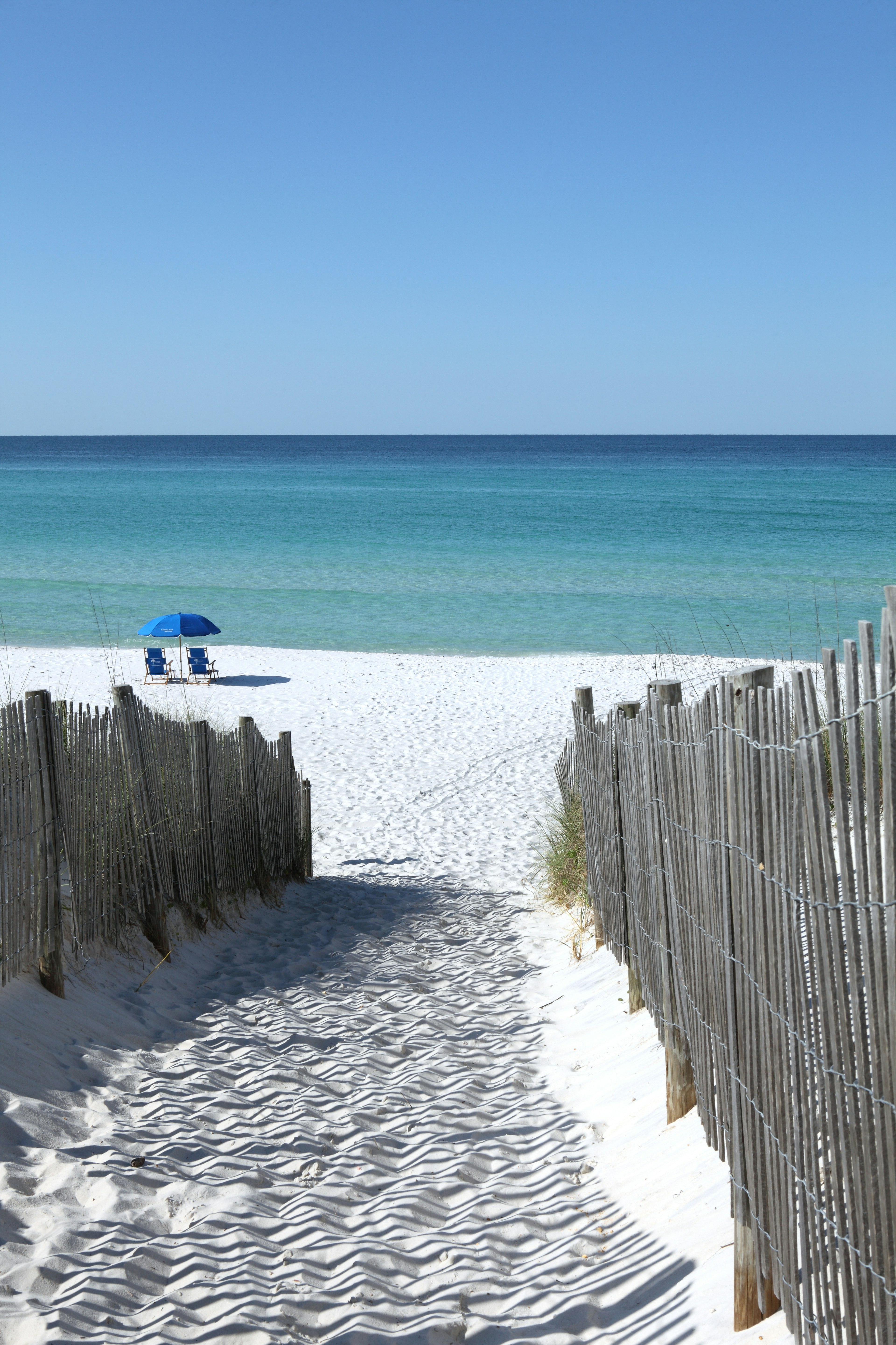 Fences line the walkway by the dunes at the public beach in Seaside, Florida, near Grayton Beach State Park